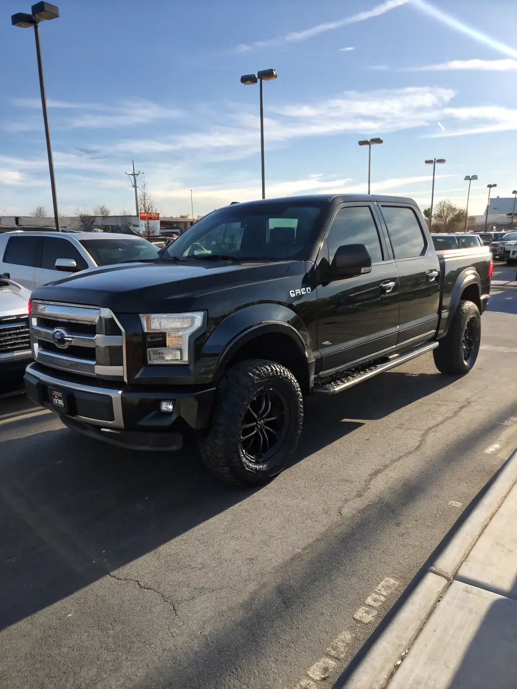 A 2018 Ford F-150 in a sleek silver color, showcasing its bold front grille, muscular body lines, and large wheels. The truck features a spacious cab with a well-designed dashboard and comfortable seating. The bed is open, highlighting its ample cargo space.
